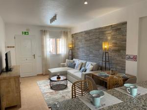 a living room with a couch and a table at Villa Saladillo Camposol Holiday Home in Mazarrón