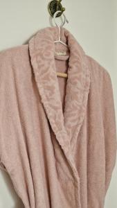 a pink blanket is hanging on a hook at La maison du Mont Saint Michel in Pontorson