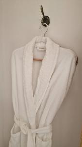 a white towel is hanging on a hook at La maison du Mont Saint Michel in Pontorson
