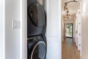 a washer and dryer in a hallway of a house at Beautiful Oceanview, Great Location Across the Beach in Wailea