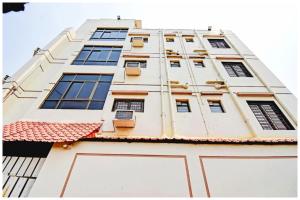 a tall white building with windows at HOTEL SUPERIOR ELITE INN Best HOTEL IN KOLKATA in Belgachia