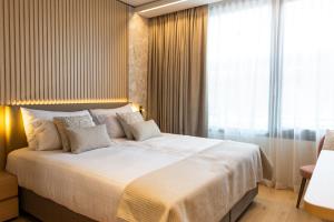 Postel nebo postele na pokoji v ubytování Hôtel des Innovations