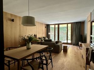 a living room with a table and a couch at Isard Homes by Select Rentals in El Tarter