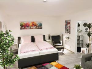 a bedroom with a bed and a chair at MeerZeit in Dahme