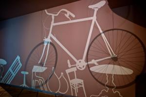 a bike painted on a wall with furniture at Bed+Art Milano Centrale in Milan