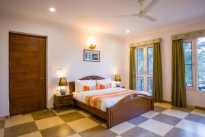 a bedroom with a bed and a window at Alaya Stays Captains Nest 3 BHK Retreat With Garden & Scenic Views in Kasauli