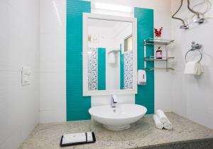 a white bathroom with a sink and a mirror at Alaya Stays Captains Nest 3 BHK Retreat With Garden & Scenic Views in Kasauli +79 photos