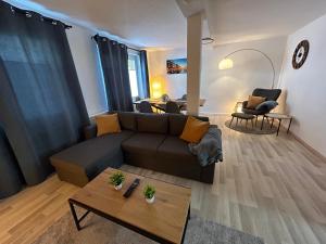 a living room with a couch and a table at Schönes 4-Zimmer Appartment, WLAN, Küche, BAD in Ilmenau