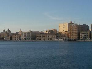 a city with a large body of water and buildings at L'Azzurro Apartment in Valderice