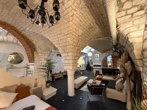 a large living room with a stone wall at Capsule Arkéa Souplex in Arras
