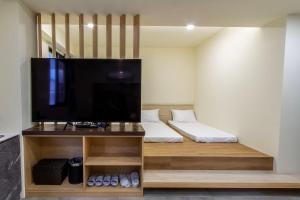 a living room with a large flat screen tv at 晨煦行旅 in Lugu Lake