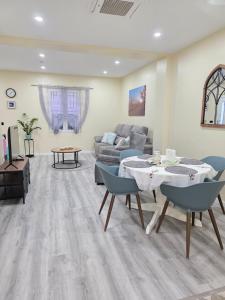a living room with a table and a couch at Casa Rosa in Pinoso