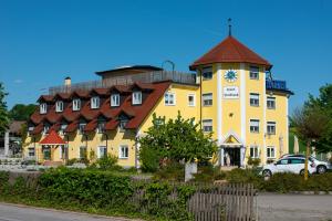 a large yellow building with a clock on it at Hotel Haslbach FGZ in Regensburg