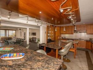 a kitchen with a table and chairs in a room at At Doms B&B in Ballito