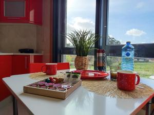a table with a box of chocolates and a bottle of water at Apartamento luminoso y acogedor in Salvatierra de Miño