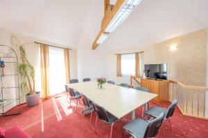 a conference room with a table and chairs at Hotel Haslbach FGZ in Regensburg