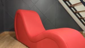 a red chair sitting next to a staircase at Love Room Perpignan Jacuzzi & Ambiance romantique in Villeneuve-de-la-Raho