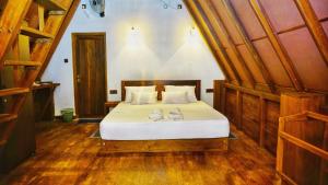 a bedroom with a bed with two shoes on it at Eco Breath Cabana in Sigiriya