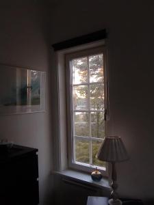 a window in the corner of a room with a lamp at Villa Markomby in Markomby +20 photos