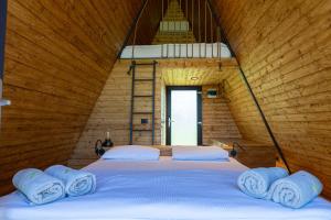 a bedroom with a bed with towels on it at Perryland Urban Farm in Piatra +83 photos