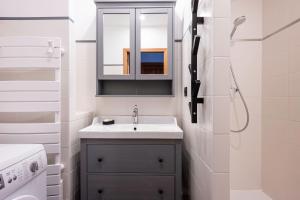 a white bathroom with a sink and a shower at Près du Mélèze-Val Cenis-Sardières in Val Cenis +36 photos