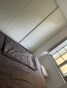 a bed in a room with a window at Centre ville T3 in Saumur