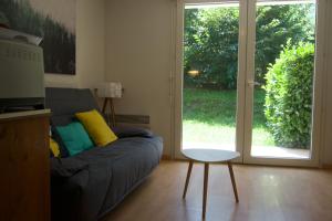 a living room with a couch and a sliding glass door at Clos saint michel in Luz-Saint-Sauveur