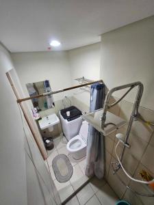 a small bathroom with a toilet and a sink at SMDC Field REsidences condo unit in Manila