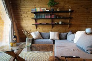a living room with a couch and a glass table at Perryland Urban Farm in Piatra