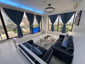 a living room with blue curtains and a couch at 88th Avenue in Cebu City