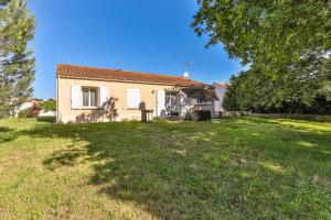 a house with a large yard in front of it at Les Pinsons - Jardin - Parking - Wifi in Challans