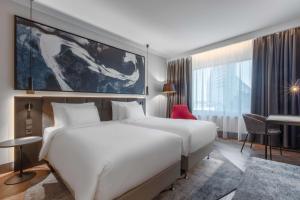 A bed or beds in a room at Radisson Collection Hotel, Tallinn