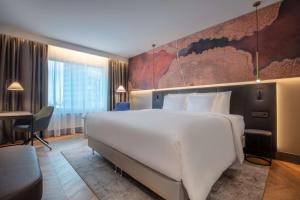 A bed or beds in a room at Radisson Collection Hotel, Tallinn