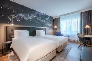 A bed or beds in a room at Radisson Collection Hotel, Tallinn