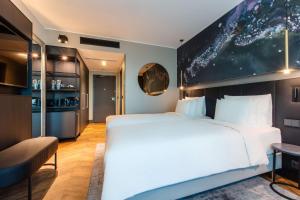 A bed or beds in a room at Radisson Collection Hotel, Tallinn