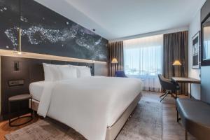 A bed or beds in a room at Radisson Collection Hotel, Tallinn