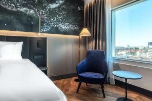 A bed or beds in a room at Radisson Collection Hotel, Tallinn
