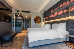 A bed or beds in a room at Radisson Collection Hotel, Tallinn
