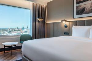 A bed or beds in a room at Radisson Collection Hotel, Tallinn