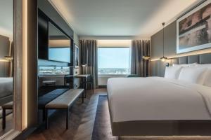 A bed or beds in a room at Radisson Collection Hotel, Tallinn
