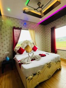 a bedroom with a large bed with red pillows at TheGod Gift Hotel in Orchha