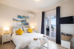 a bedroom with a bed and a view of the ocean at Unique apartment in Corfu Town +50 photos