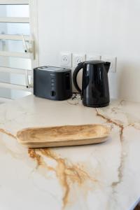 a black toaster sitting on a counter with a cutting board at ONLY4VIEW Saint françois in Saint-François