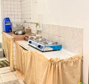 a kitchen with a stove top on a counter at Inn Convenience in Coron