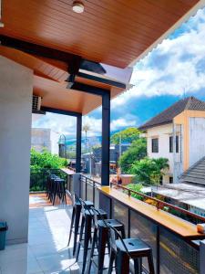a balcony with chairs and a bar with a view at Adyvan Villa in Malang