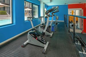 a gym with several tread machines in a room at Cape Town Condo J13 at The Adderley in Cape Town