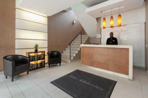 a man standing at a counter in a lobby at Cape Town Condo J13 at The Adderley in Cape Town +24 photos