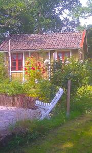 a bench in front of a small house at Boråkra Bed & Breakfast in Karlskrona