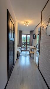 a room with a hallway with a door and a bedroom at Sosnowa Polana Białowieża in Białowieża