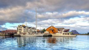 two boats docked at a dock in the water at Anker Brygge in Svolvær +131 photos